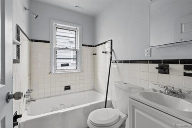 Full bathroom with vanity, tile walls, and shower / bath combination
