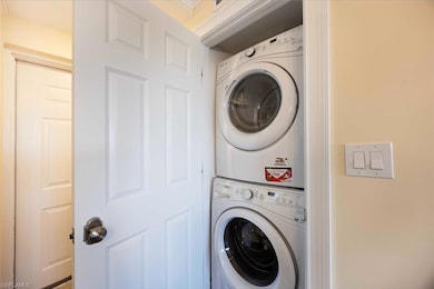 Laundry area with stacked washing machine and dryer