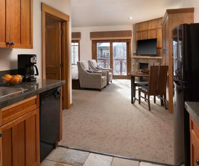 Kitchen featuring black appliances, brown cabinetr