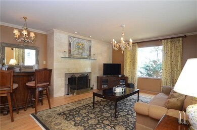 The living room includes a fireplace with tile sur