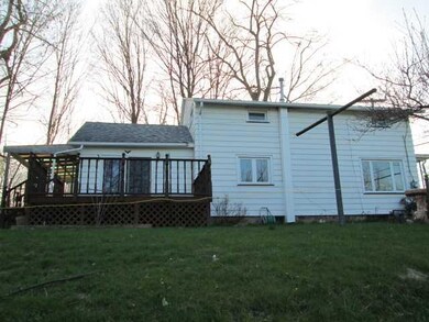 Exterior Back SLIDING GLASS DOORS LEAD TO LARGE DE