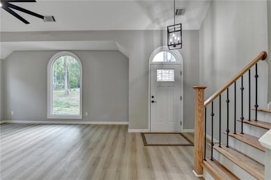 Entryway featuring stairway, light wood-style floo