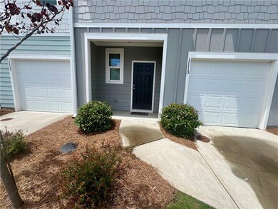 Entrance to property featuring driveway and board 
