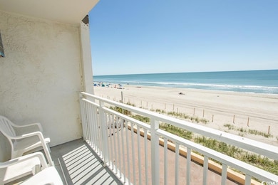 Balcony with a water view and a view of the beach