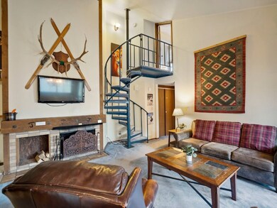 Carpeted living room featuring a high ceiling and