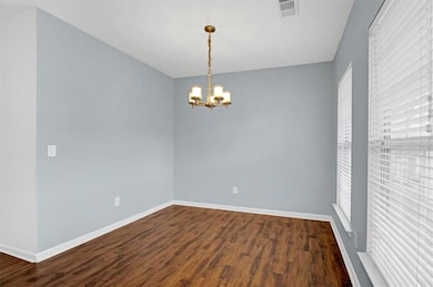 Empty room featuring visible vents, baseboards, da