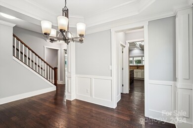Dining room looking back to he butlers pantry and kitchen stairs to upper level.