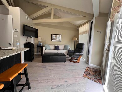 Living room with light wood-type flooring and baseboards