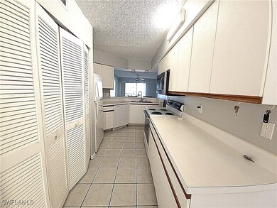 Kitchen featuring white cabinetry, white appliance