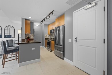 Kitchen with tasteful backsplash, stainless steel appliances, rail lighting, dark stone countertops, and brown cabinetry