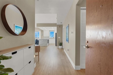 Hallway featuring light wood-style flooring and ba