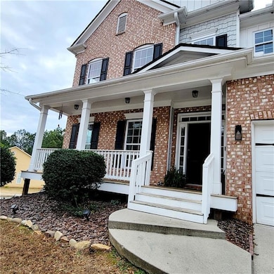 Doorway to property featuring covered porch