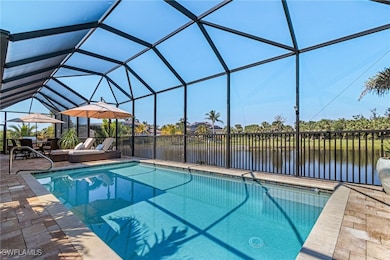View of pool with glass enclosure, a patio, and a