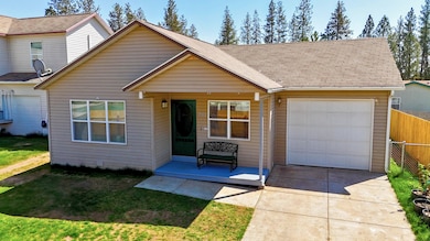 View of front of house featuring an attached garage, concrete driveway, and a porch