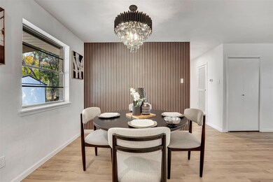 Dining space with a chandelier and light hardwood 