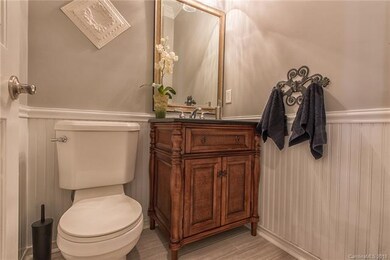 Main level half bathroom next to office.