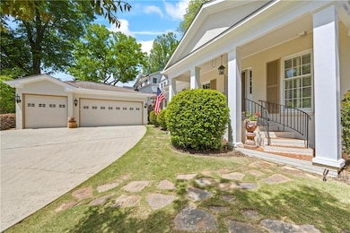 View of property exterior with an attached garage,