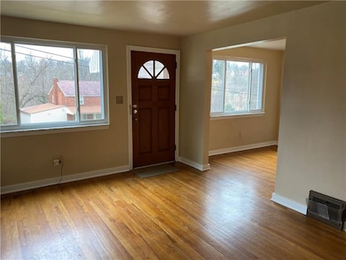 LIVING ROOM, LARGE WINDOW AND HARDWOOD FLOORING.