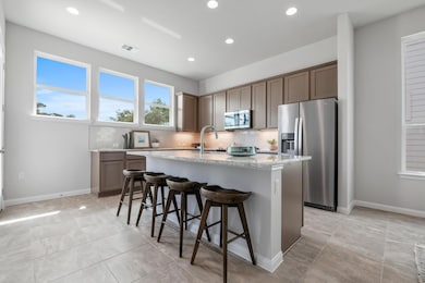 Kitchen with light stone counters, a sink, a kitc