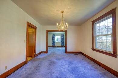 Dining room looking into living room, kitchen on t