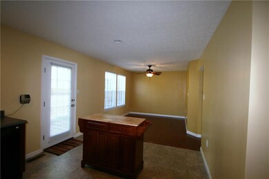 Kitchen looks into the dining room. Door to the ba