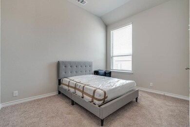 Bedroom with light carpet, visible vents, baseboa