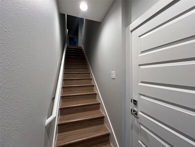 Staircase featuring a textured wall