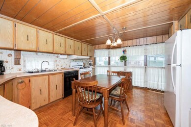 Kitchen featuring parquet floors, white appliances