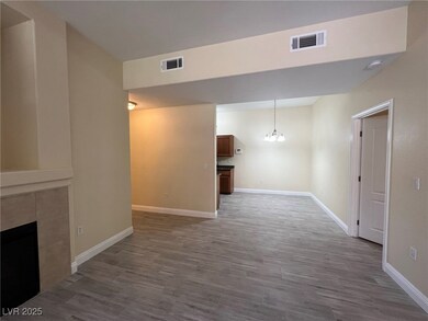 Unfurnished living room featuring a chandelier, light wood-type flooring, and a fireplace