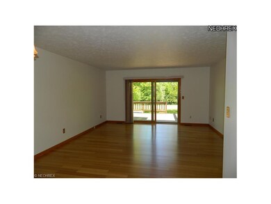 Large family room leading to deck overlooking golf