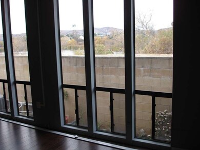 Living room/office area, windows with view