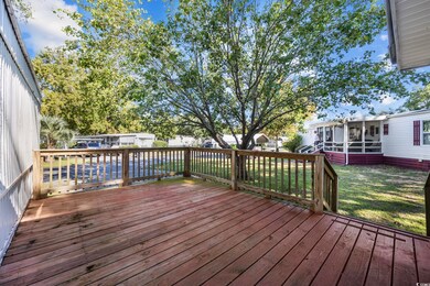 Deck with a sunroom and a lawn