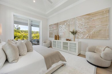 The primary bedroom overlooks the pool deck and fu