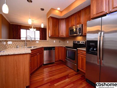 Cherry cabinetry, granite countertops, glass tile backsplash, Stainless Steel Appliances, wood floors.