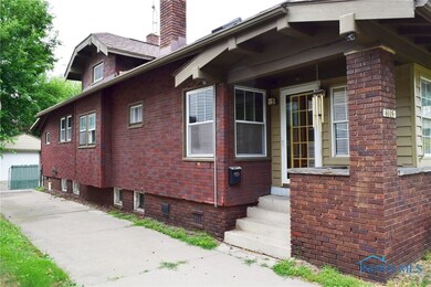 Side of home with entrance to front door