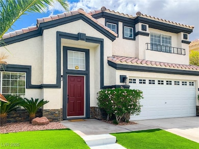 View of front of home with a tile roof, an attache