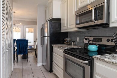 Kitchen with stainless steel appliances, white cab