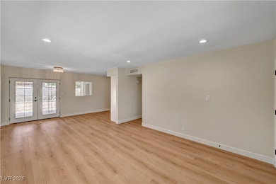Unfurnished living room featuring baseboards, rece