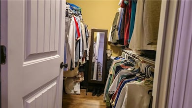 Walk in closet featuring wood finished floors