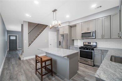 Brand new kitchen with quartz countertops.