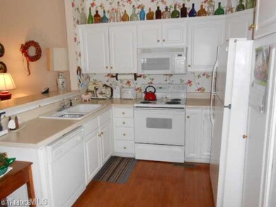 Kitchen. Open kitchen to dining area. Eating Counter. Door exits to Large deck overlooking georgous pond.
