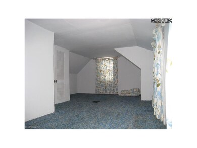 View of the master bedroom with 2 closets and a 1/2 bath.  Hardwood flooring is beneath the wall to wall carpeting.