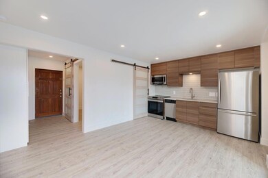 Kitchen featuring a barn door, light countertops,