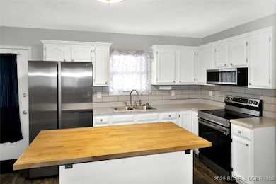 Stainless Appliances w/ Tiled Backsplash