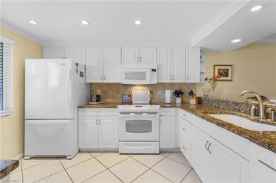 Kitchen featuring dark stone counters, crown moldi