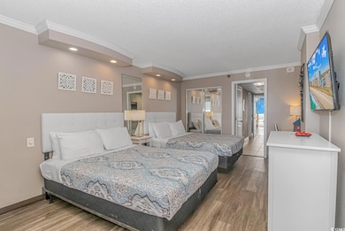 Bedroom with ornamental molding, a textured ceilin