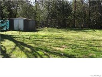 Large Fully Fenced backyard with detached storage.
