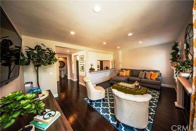 Cozy family den with elegant wood floors, baseboar