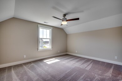 Additional living space featuring lofted ceiling, 