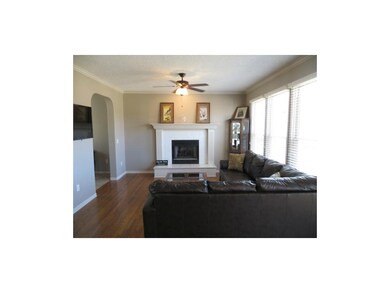 Family room with fireplace, ceiling fan and 2